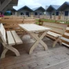 a wooden table and benches on a deck